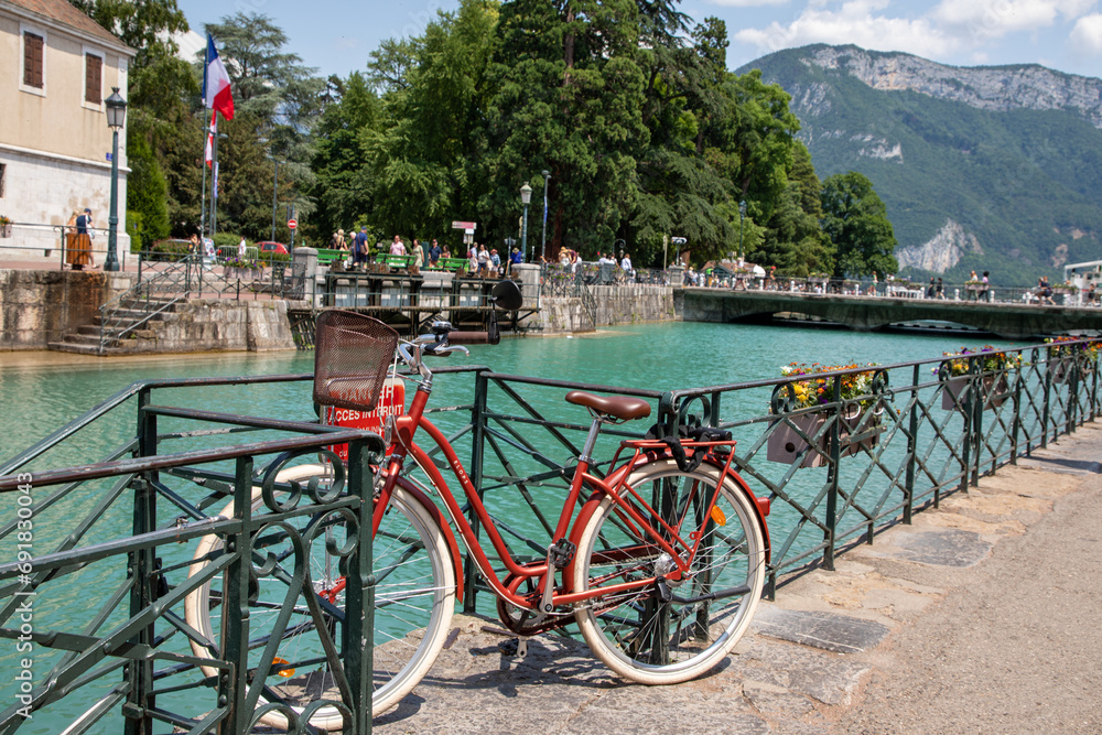 bicycle parked aside the river canal on the Annecy old town in alps french bicycle parked aside the river canal on the Annecy old town in alps french