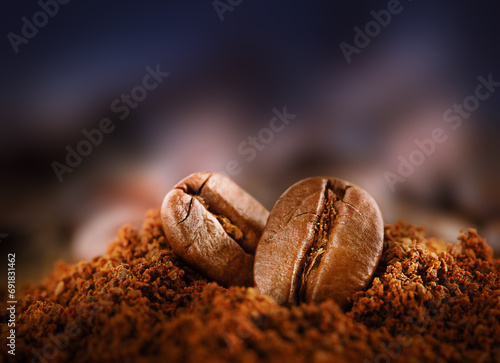 two coffee beans among ground coffee