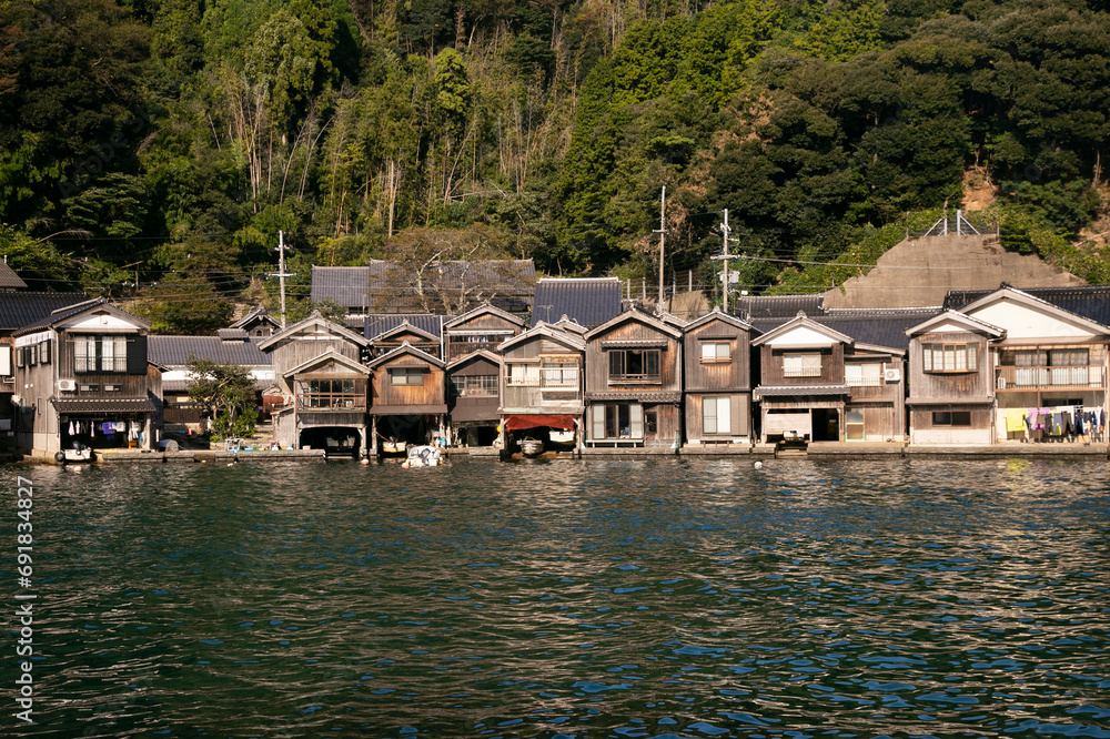 Fototapeta premium Beautiful fishing village of Ine in the north of Kyoto. Funaya or boat houses are traditional wooden houses built on the seashore.