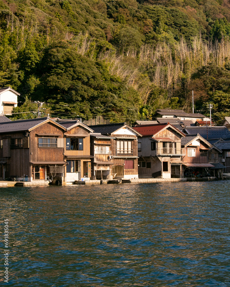 Fototapeta premium Beautiful fishing village of Ine in the north of Kyoto. Funaya or boat houses are traditional wooden houses built on the seashore.