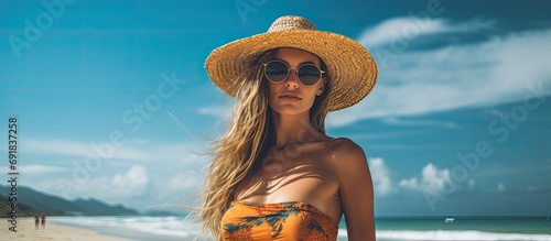 background of a stunning beach, a woman exudes summer fashion as a confident girl enjoying the sea, adorned in vibrant colors her vacation style perfectly captures the essence of a modern and sexy
