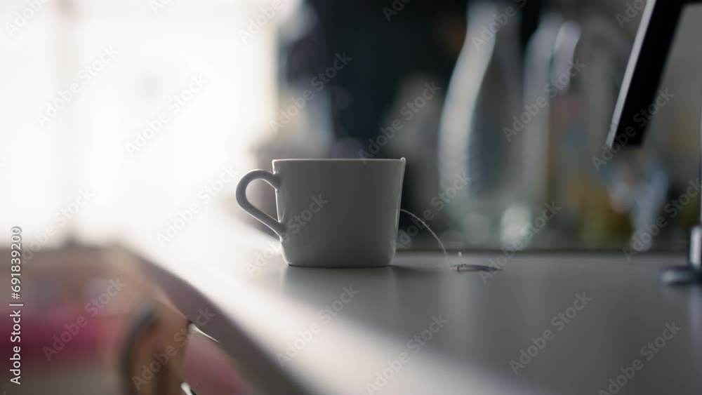 Serene morning with a hot mug on a kitchen counter. Steam rises from a ...
