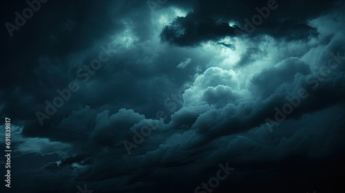 dark blue sky with clouds. Black dark greenish blue night sky. Gloomy ominous storm rain clouds background.