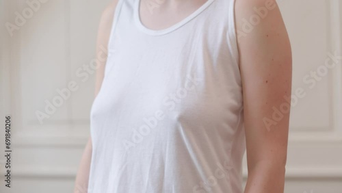 Woman without bra comfortably wearing tank top  photo