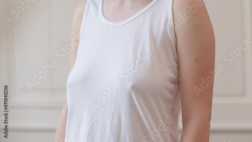 Woman without bra comfortably wearing tank top 
