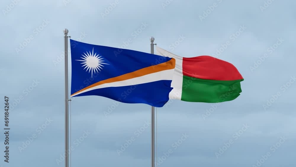 Madagascar flag and Marshall Islands flag waving together on cloudy sky, endless seamless loop, two country relations concept Madagascar flag and Marshall Islands flag waving together on cloudy sky, endless seamless loop, two country relations concept