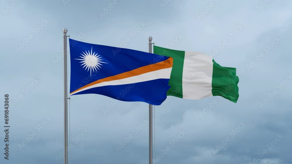 Nigeria flag and Marshall Islands flag waving together on cloudy sky, endless seamless loop, two country relations concept Nigeria flag and Marshall Islands flag waving together on cloudy sky, endless seamless loop, two country relations concept