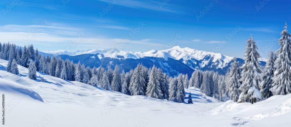 Winter mountain landscape in Carinthia, Austria with snow, pine forest, and clear sky.