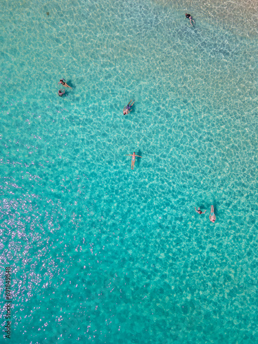 people swimming in a blue turqouse colored ocean at Koh Samet Island Thailand, aerial drone view from above at the Samed Island in Thailand  © Fokke Baarssen