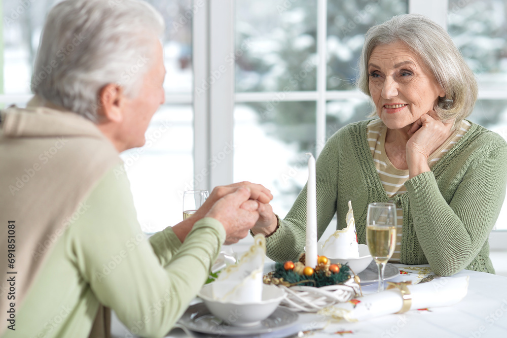 Elderly couple at the dinner table with champagne. Elderly couple at the dinner table with champagne.