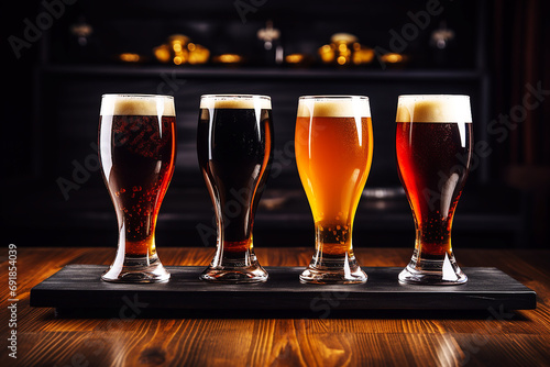 Set of different types of beer on a dark background in a bar