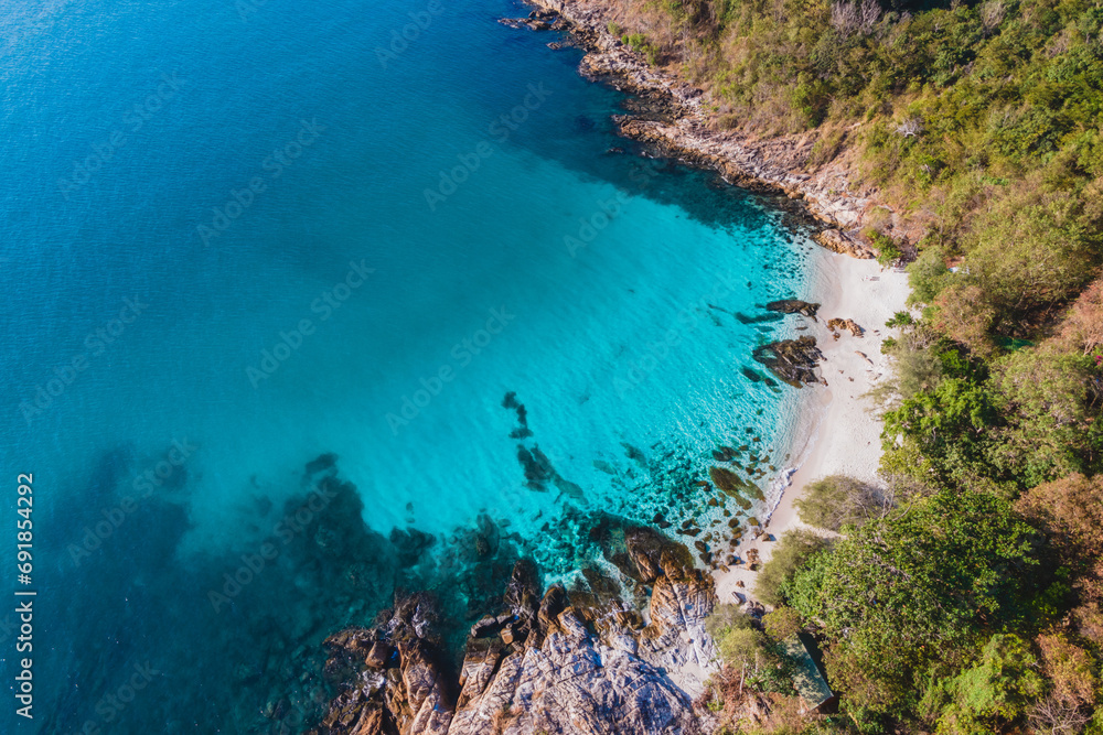 A tropical bay lagoon at Koh Samet Island Thailand, aerial drone view from above at the Samed Island in Thailand with a turqouse colored ocean and a white tropical beach