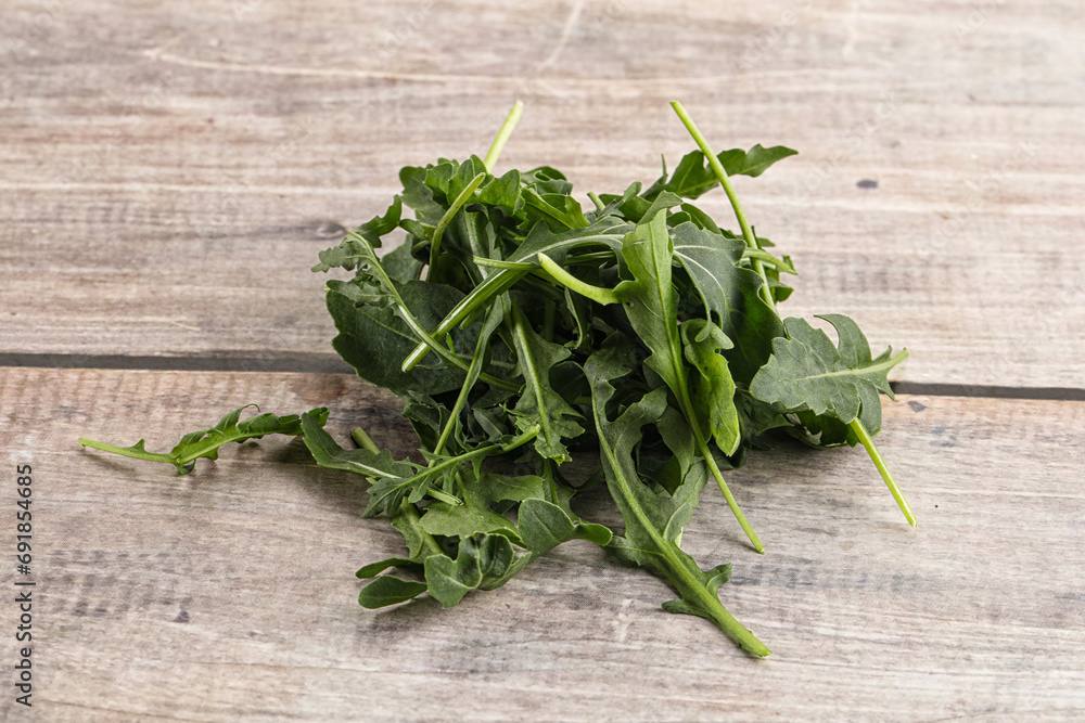 Green Arugula heap over background Green Arugula heap over background