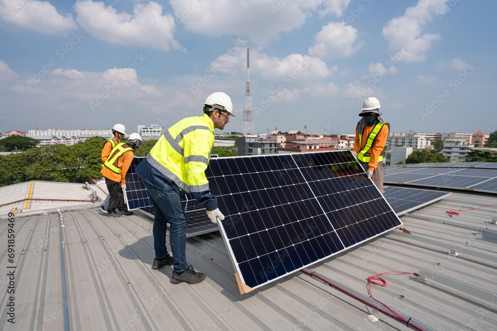 custom made wallpaper toronto digitalMen technicians carrying photovoltaic solar moduls on roof of factory on the morning. Installing a Solar Cell on a Roof. Solar panels on roof. Workers installing solar cell power plant eco technology.