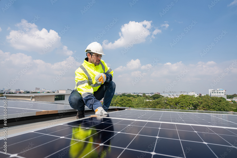Engineers in helmets installing solar panel system outdoors. Installing a Solar Cell on a Roof. Solar panels on roof. Workers installing solar cell power plant eco technology. Engineers in helmets installing solar panel system outdoors. Installing a Solar Cell on a Roof. Solar panels on roof. Workers installing solar cell power plant eco technology.