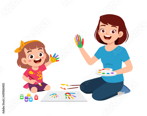 little kid and mother using hand to make paint art