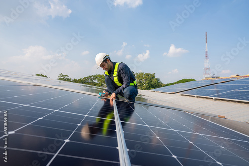 Engineer service check installation solar cell on the roof of factory. Silhouette technician inspection and repair solar cell on the roof of factory. Technology solar energy renewable. photo