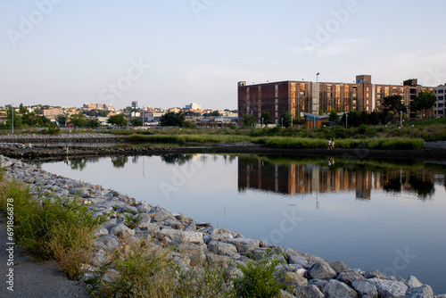 Scenic view of a river flowing located near a park in Brooklyn, New York