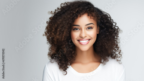 Beautiful young smiling african american woman with curly hair portrait. Fashion, beauty and make up portrait.