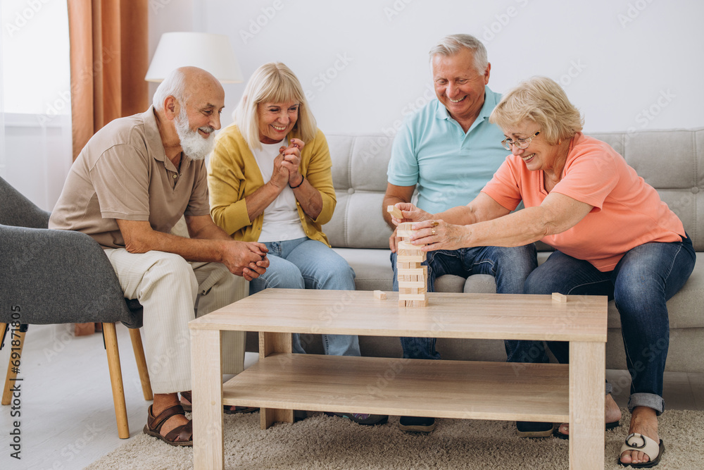 Group of happy senior people having fun and playing board games in retirement home Group of happy senior people having fun and playing board games in retirement home
