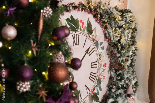 gorgeous Christmas and New Year decor featuring Christmas clock decorated with snowy tree branches and other Christmas decorations: Christmas tree, snowman, gifts photo