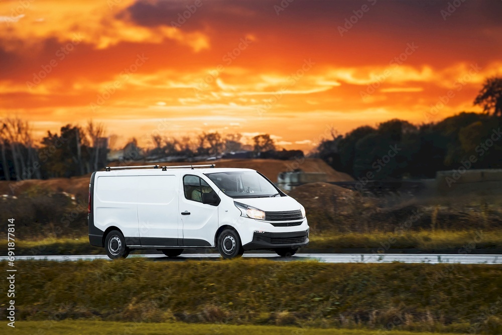 Fast-Moving White Delivery Van on Urban Highway. Distribution and Logistics in Action. Modern Delivery Van on the Road. Shipping and distribution concept. Fast-Moving White Delivery Van on Urban Highway. Distribution and Logistics in Action. Modern Delivery Van on the Road. Shipping and distribution concept.