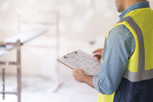 Konstfotografi Professional architect studying project drawing of house renovation holding clip