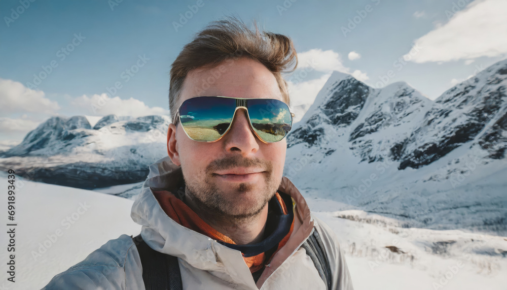 Man in mirrored sunglasses on the mountains