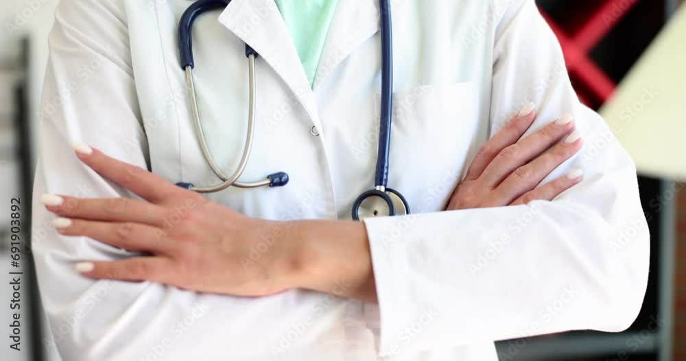 Confident female doctor therapist standing with arms crossed on chest closeup. Medical care or insurance concept Confident female doctor therapist standing with arms crossed on chest closeup. Medical care or insurance concept