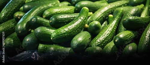 A big pile of cucumbers on display in a store. Copy space image. Place for adding text