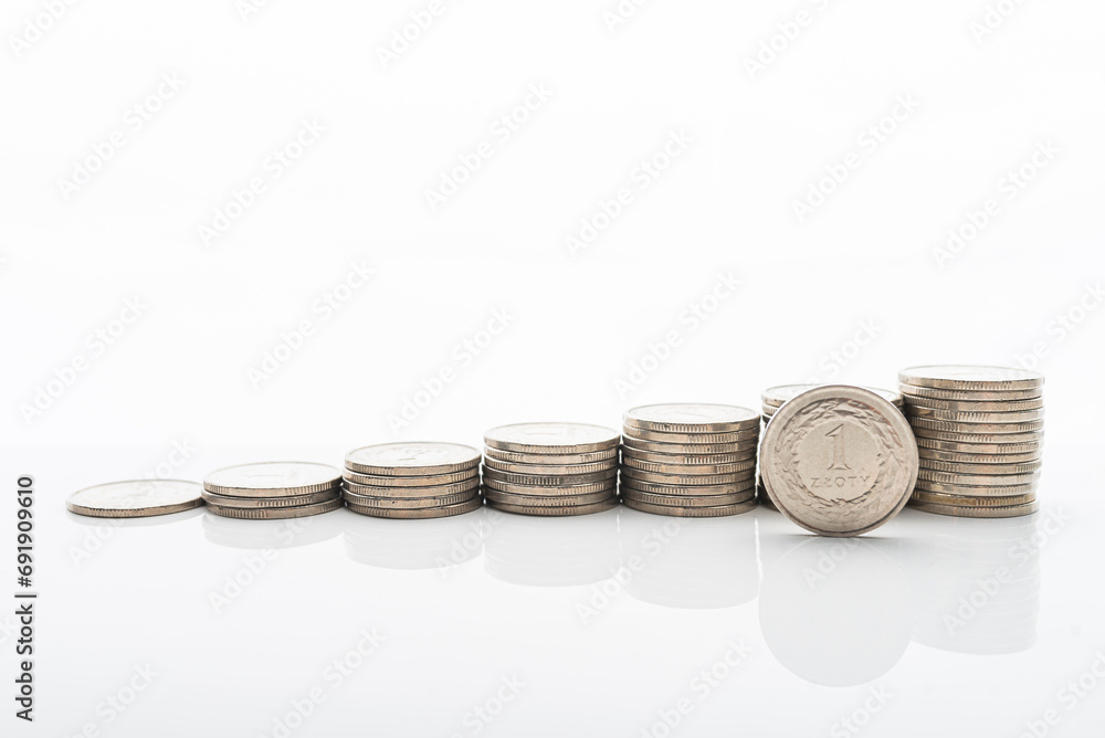 Polish Zloty coins stacked on white backgroud with smooth reflection. Concept of grow, investment, saving money. 1 PLN coint standing on the stack. Polish Zloty coins stacked on white backgroud with smooth reflection. Concept of grow, investment, saving money. 1 PLN coint standing on the stack.
