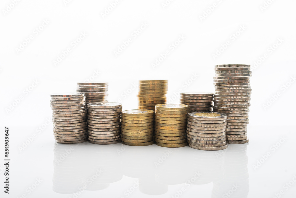 Coins stacked on white backgroud with smooth reflection. Concept of home buget, saving money, wealth. Coins stacked on white backgroud with smooth reflection. Concept of home buget, saving money, wealth.