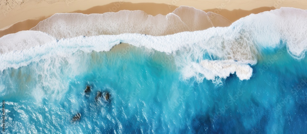 Aerial picture of blue shallow water and rocks at the beach Location Bremer Bay in South west Australia Drone view Ocean white sand and rocks with small waves and foamy water. Copy space image Aerial picture of blue shallow water and rocks at the beach Location Bremer Bay in South west Australia Drone view Ocean white sand and rocks with small waves and foamy water. Copy space image