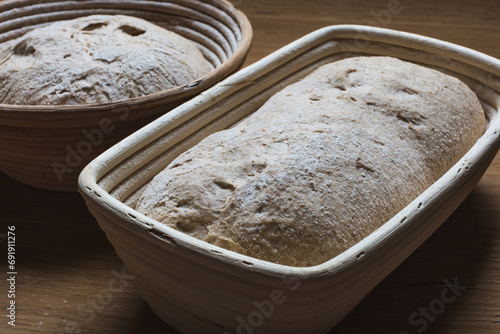 Bread proofing Whole grain dough in rattan baskets before baking Yeast-free sourdough bread photo