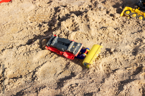 Children's toy car in the sand closeup