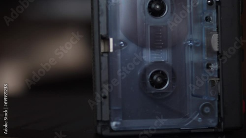 close-up of a vintage audio cassette playing music in an audio player. musical equipment from the 80s. audio cassette records music photo