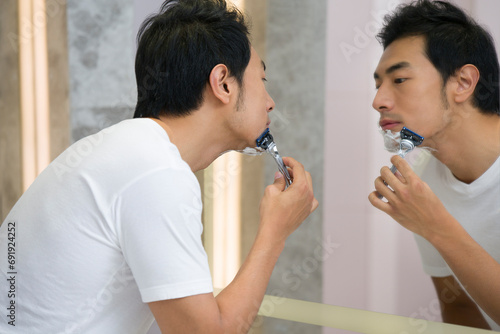 Young man shaving photo