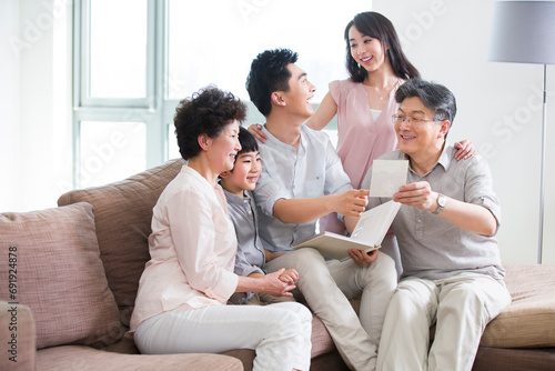 Happy family looking at photo album photo