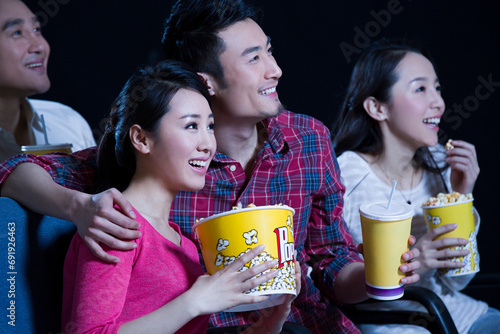 Young couple watching movie in cinema photo