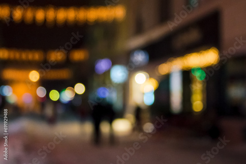 city street at christmas holidays night. blurred festive urban background with bokeh effect © Pellinni