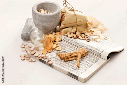 Traditional Chinese herbal medicine therapy with ancient Chinese medical book photo