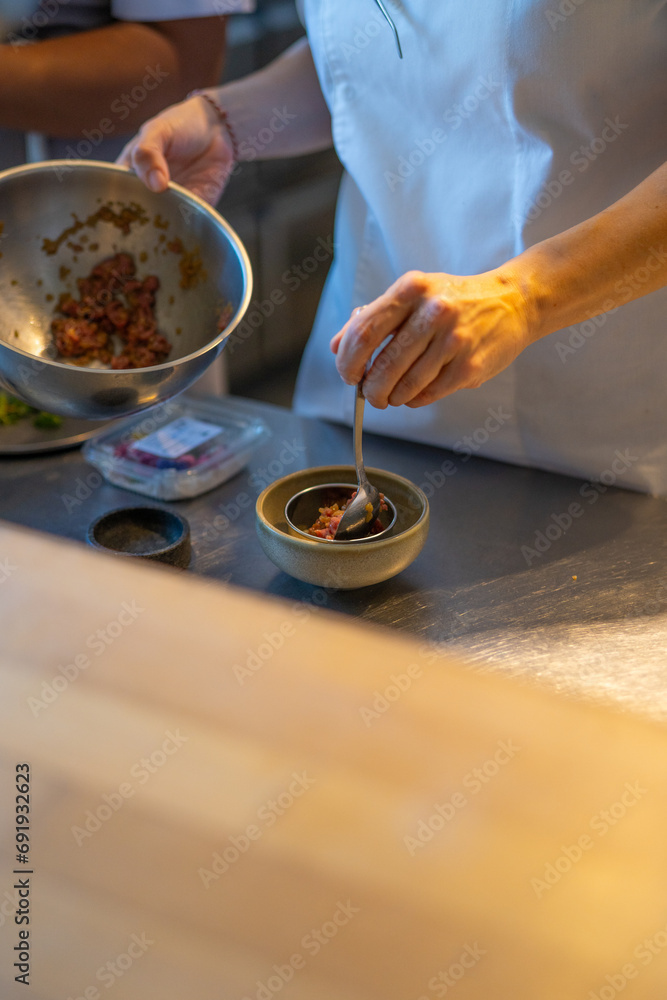 Fototapeta premium chef plating food in plate while working in commercial kitchen