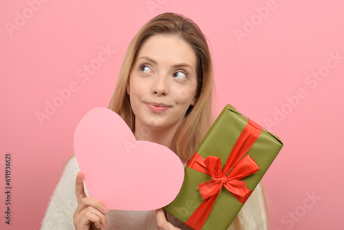 cute woman holding a gift box on valentine's day
