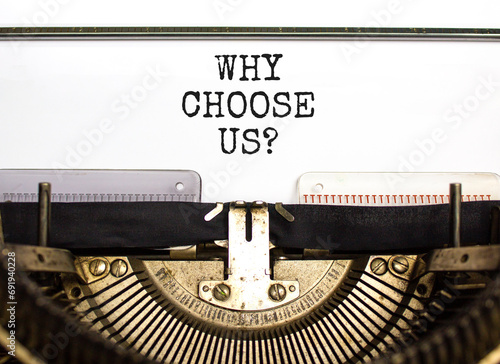 Why choose us symbol. Concept word Why choose us typed on beautiful retro old typewriter. Beautiful white paper background. Business motivational why choose us concept. Copy space.