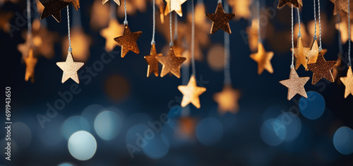 Christmas and New Year holidays background with silver and gold stars on bokeh background.