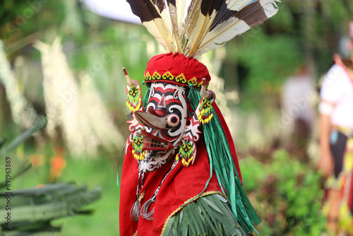 the portrait of hudoq dancers marching in order to perform sacred rituals performed by indigenous tribes     photo