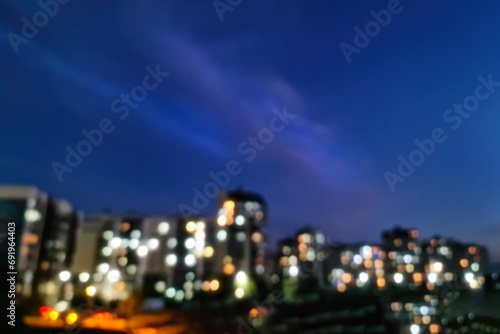 Residential area blurred background, microdistrict on the outskirts of the city with electric lighting on in the evening after sunset, copy space. photo