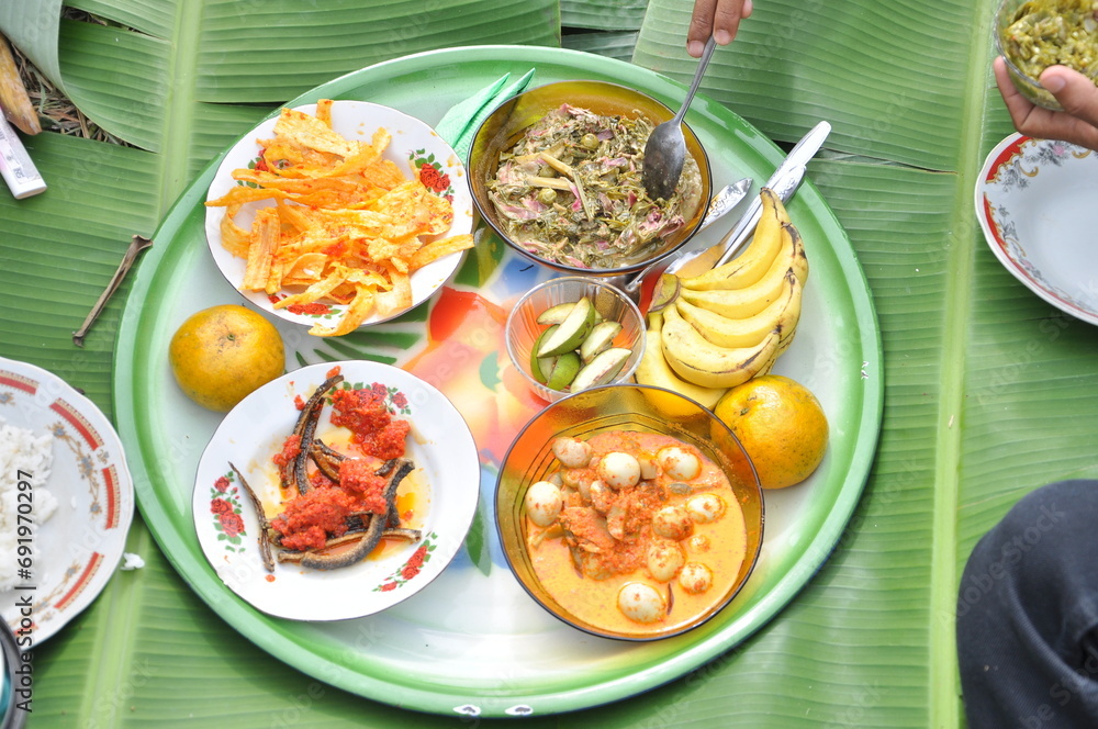 Some foods in the tray for Makan Bajamba in Minangkabau Land
