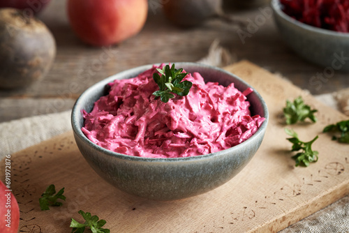 Fresh beetroot salad with apples and sour cream in a bowl