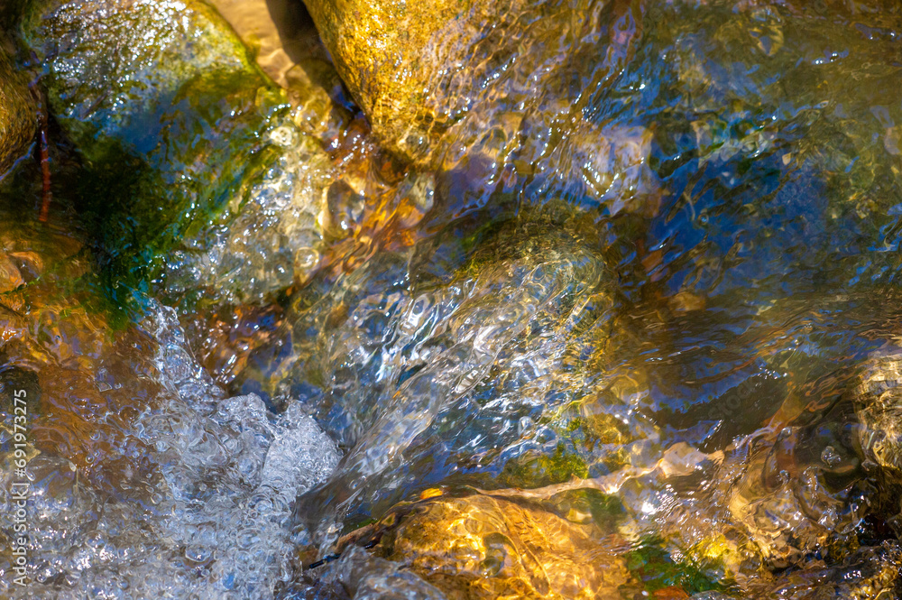 Immerse yourself in the tranquility of a picturesque stream. Enjoy crystal clear water flowing over moss-covered rocks. Relax to the soothing sounds and refreshing atmosphere.